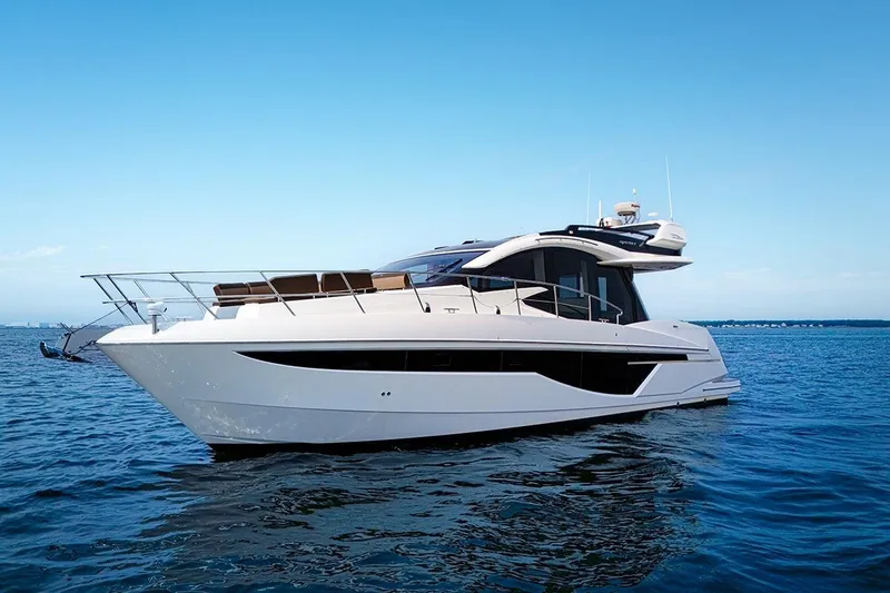 Slide: The Image of 2023 Galeon 470 Sky yacht cruising on open water under clear blue sky. - 6