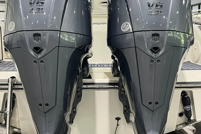 Slide: The Image of Twin V6 outboard engines on a 2024 Cobia 265 Open Center Console boat. - 10