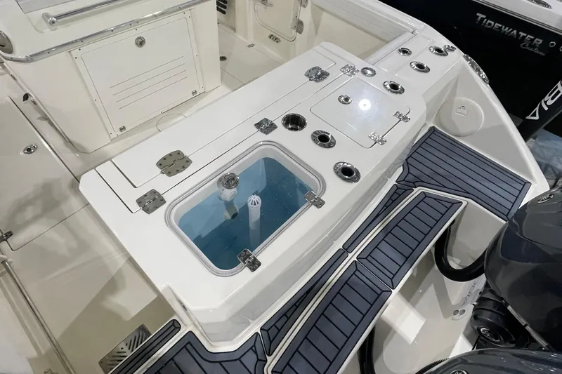 Slide: The Image of 2024 Cobia 265 Open Center Console boat with livewell and rod holders. - 13