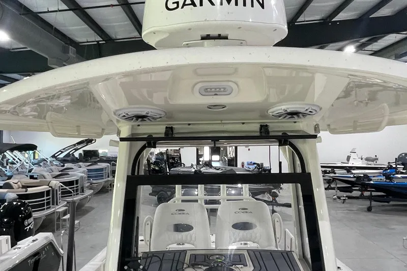 Slide: The Image of 2024 Cobia 265 Open Center Console boat interior with Garmin equipment in showroom. - 14