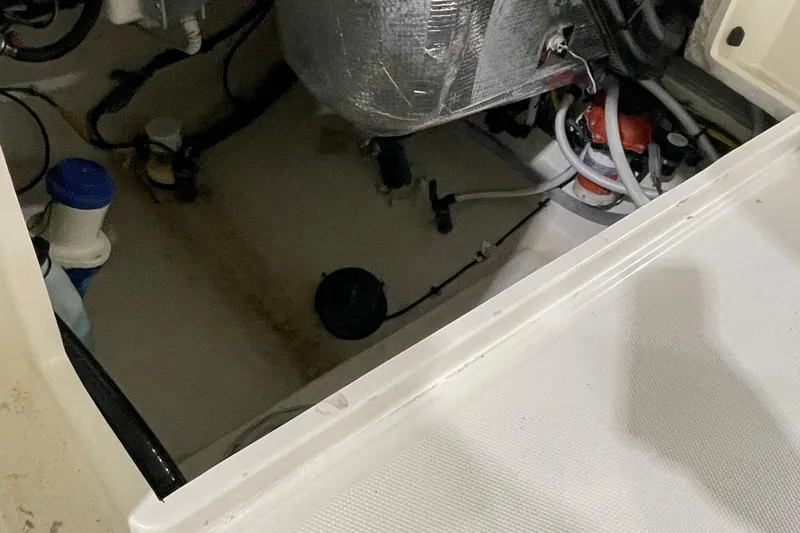 Slide: The Image of 2024 Cobia 265 Open Center Console interior, showcasing wiring and components. - 21