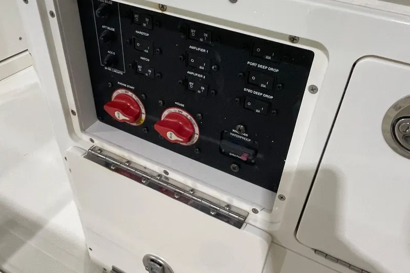 Slide: The Image of Control panel of 2024 Cobia 265 Open Center Console boat, featuring switches and dials. - 29
