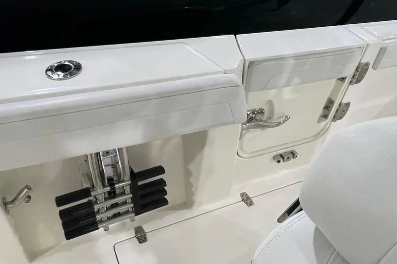 Slide: The Image of 2024 Cobia 265 Open Center Console boat interior with storage compartments and seating. - 30