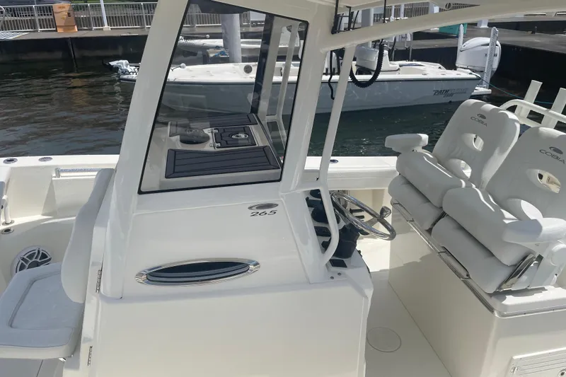 Slide: The Image of 2024 Cobia 265 Open Center Console boat interior with helm and seating. - 6