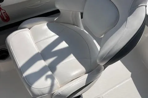 Slide: The Image of White leather seat on 2021 Chaparral 21 SSi OB boat, with sunlight and shadow. - 10