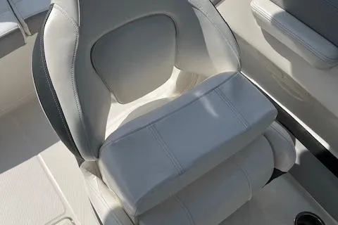 Slide: The Image of 2021 Chaparral 21 SSi OB boat seat, white and gray upholstery, close-up view. - 13