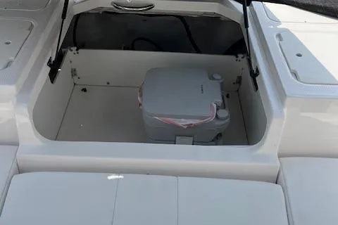 Slide: The Image of 2021 Chaparral 21 SSi OB boat storage compartment with portable toilet. - 16