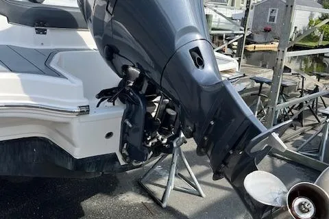 Slide: The Image of 2021 Chaparral 21 SSi OB boat with outboard motor, docked near waterfront homes. - 17