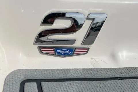 Slide: The Image of 2021 Chaparral 21 SSi OB boat emblem on white surface. - 20