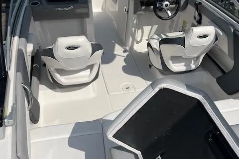 Slide: The Image of 2021 Chaparral 21 SSi OB boat interior with white seating and steering wheel. - 21