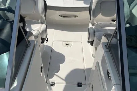 Slide: The Image of 2021 Chaparral 21 SSi OB boat interior with white seating and storage compartments. - 7