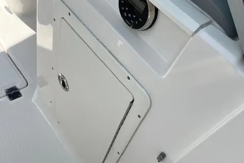 Slide: The Image of 2021 Chaparral 21 SSi OB boat interior, featuring a control panel and storage compartment. - 8