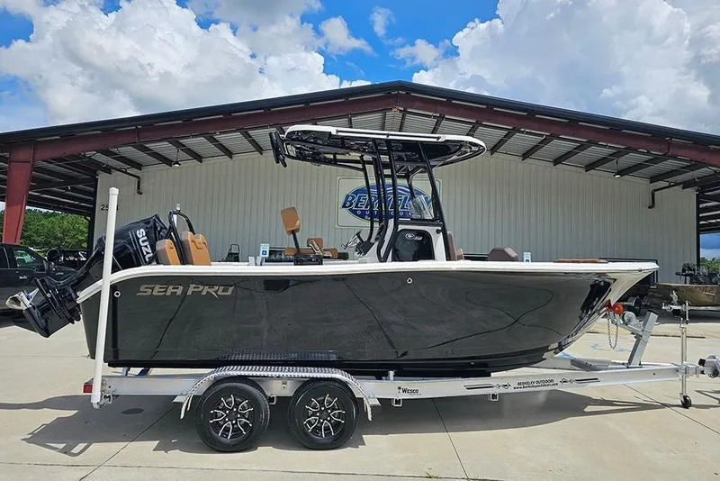 The Image of 2026 Sea Pro 225 Sandbar boat on trailer, parked outdoors under a cloudy sky. - 1