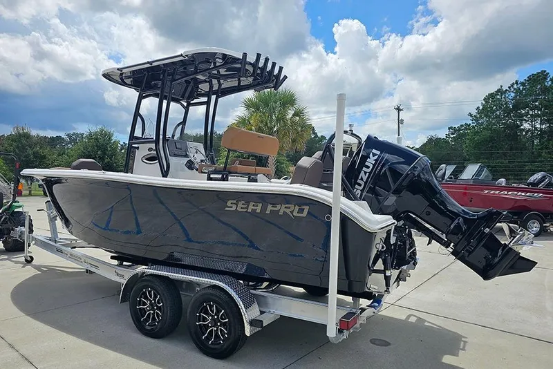 Slide: The Image of 2026 Sea Pro 225 Sandbar boat on trailer, featuring Suzuki outboard motor. - 11