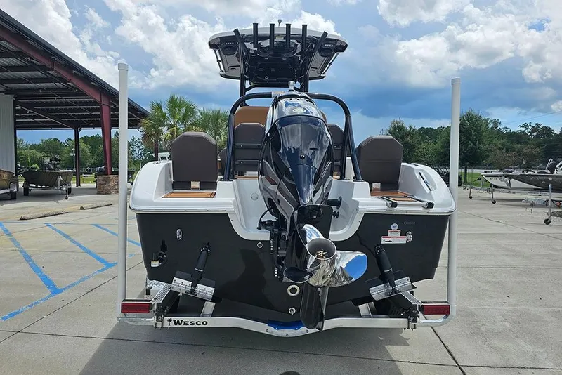 Slide: The Image of 2026 Sea Pro 225 Sandbar boat, rear view with outboard motor, parked outdoors. - 12