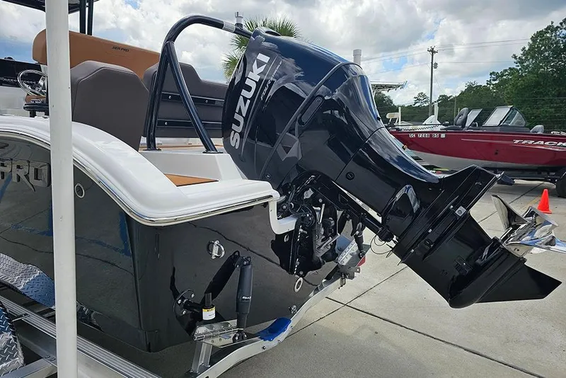 Slide: The Image of 2026 Sea Pro 225 Sandbar boat with Suzuki outboard motor, parked outdoors. - 13