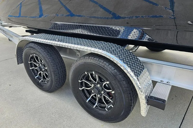 Slide: The Image of Trailer with dual wheels for 2026 Sea Pro 225 Sandbar boat, featuring diamond plate fenders. - 14
