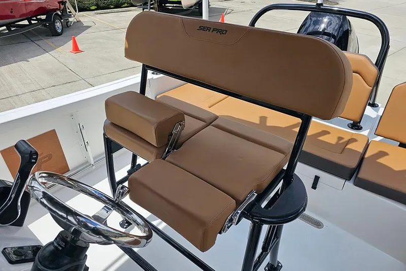 Slide: The Image of 2026 Sea Pro 225 Sandbar boat interior with brown seating and steering wheel. - 19