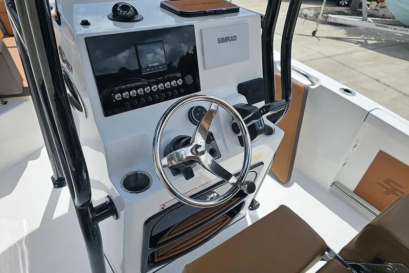 Slide: The Image of 2026 Sea Pro 225 Sandbar boat console with steering wheel and Simrad display. - 20
