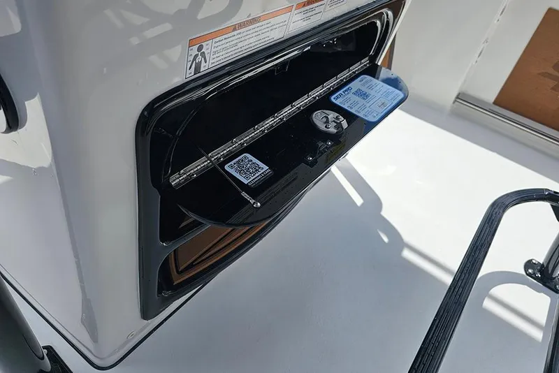 Slide: The Image of 2026 Sea Pro 225 Sandbar boat compartment with QR code and warning label. - 21