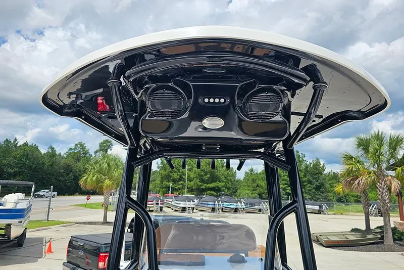 Slide: The Image of 2026 Sea Pro 225 Sandbar boat with sleek black T-top design. - 25