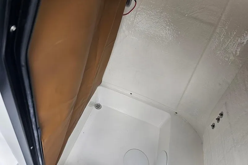 Slide: The Image of Interior view of 2026 Sea Pro 225 Sandbar boat cabin with white and brown finishes. - 28