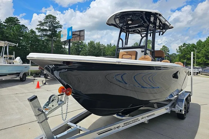 Slide: The Image of 2026 Sea Pro 225 Sandbar boat on trailer, parked outdoors under a cloudy sky. - 5