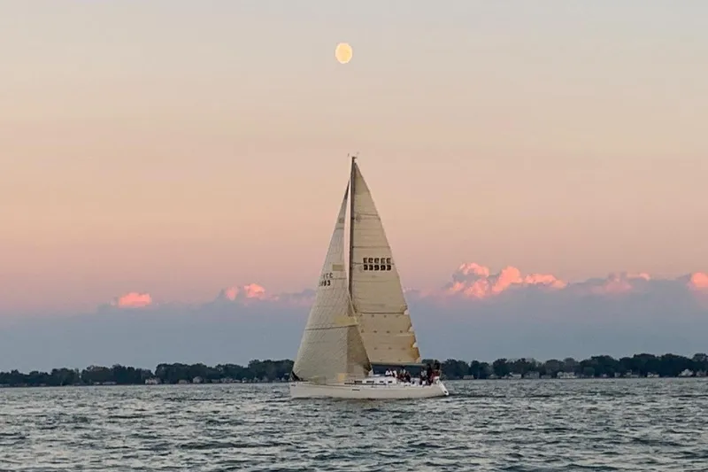 Slide: The Image of Sailboat Beneteau First 40.7, 2001 model, cruising at sunset with moon overhead. - 1