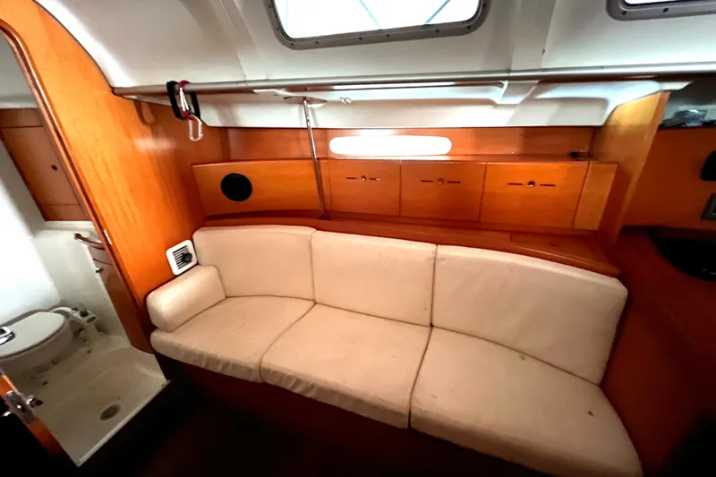 Slide: The Image of Interior of 2001 Beneteau First 40.7 yacht with beige sofa and wooden cabinetry. - 10