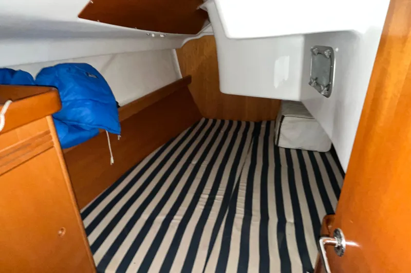 Slide: The Image of Cozy cabin interior of 2001 Beneteau First 40.7 sailboat with striped bedding. - 13