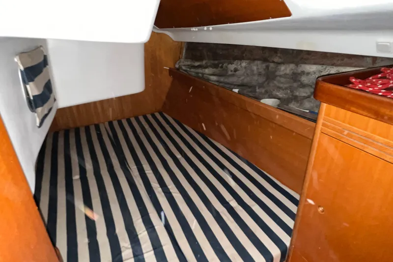 Slide: The Image of Cozy cabin interior of 2001 Beneteau First 40.7 with striped bedding. - 14