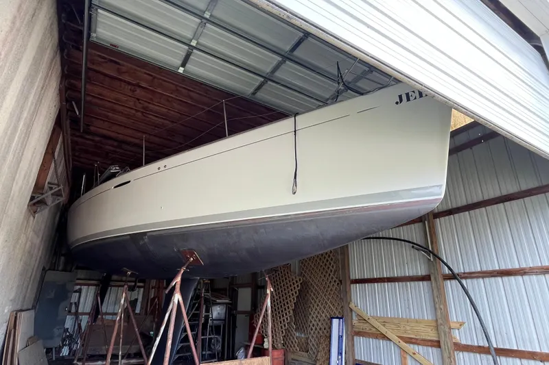 Slide: The Image of 2001 Beneteau First 40.7 sailboat stored in a metal shed on stands. - 21