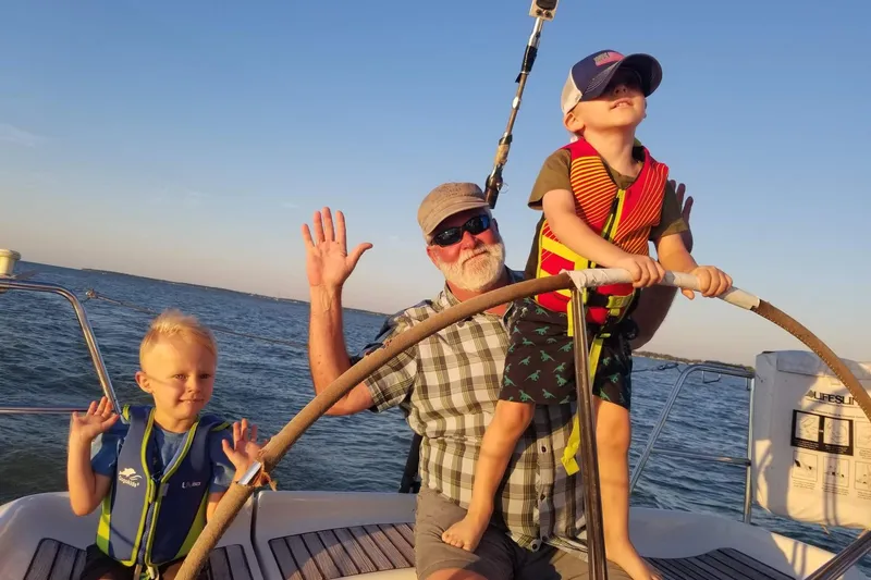 Slide: The Image of Family enjoying sailing on a 2001 Beneteau First 40.7 yacht at sunset. - 29