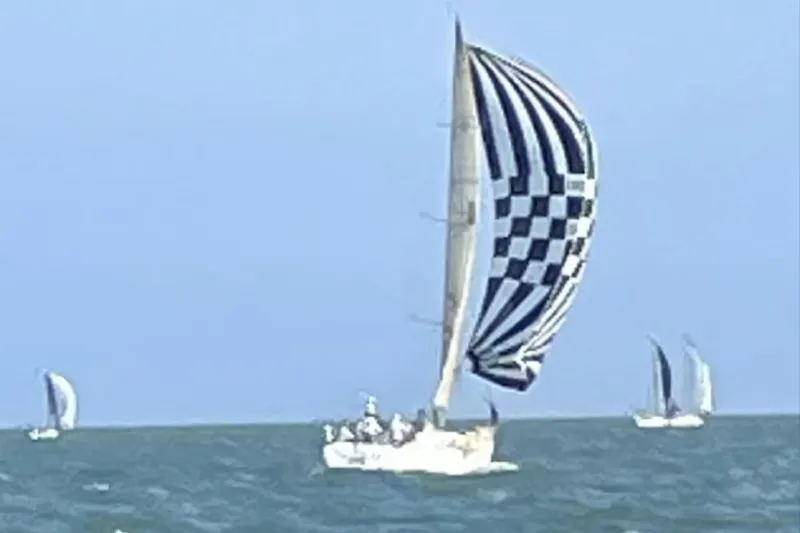 Slide: The Image of Sailboat Beneteau First 40.7 (2001) with checkered spinnaker on open sea. - 3