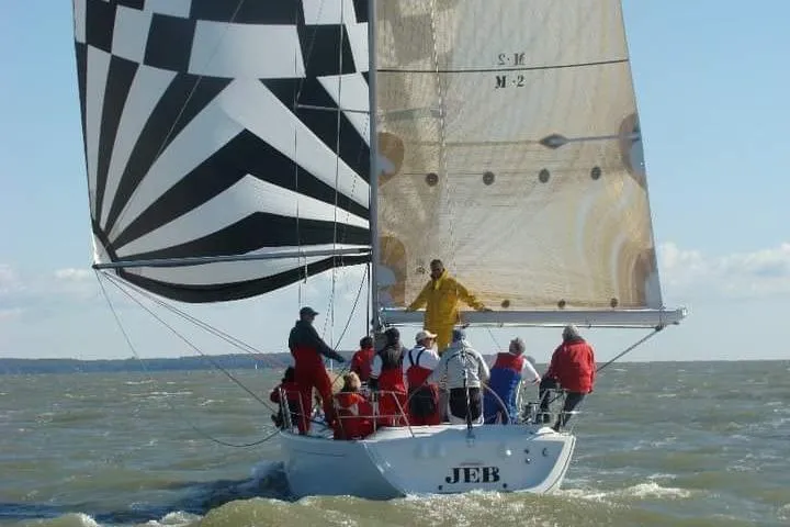 Slide: The Image of Sailing on a 2001 Beneteau First 40.7 yacht with a striped spinnaker in open waters. - 4