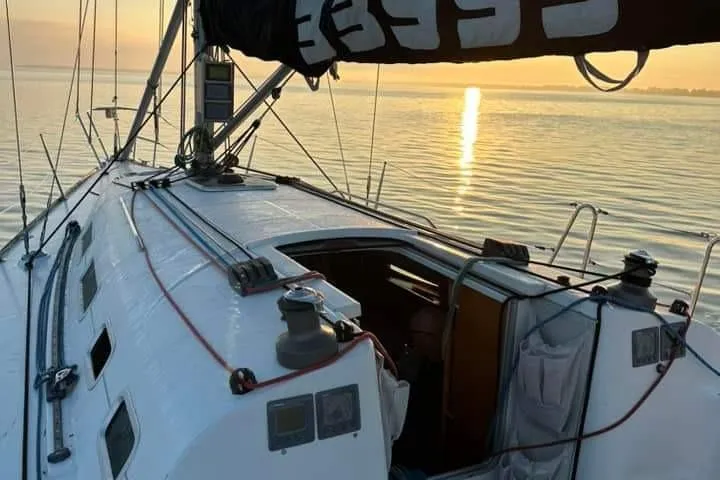 Slide: The Image of Sailing on a 2001 Beneteau First 40.7 at sunset, calm waters. - 5