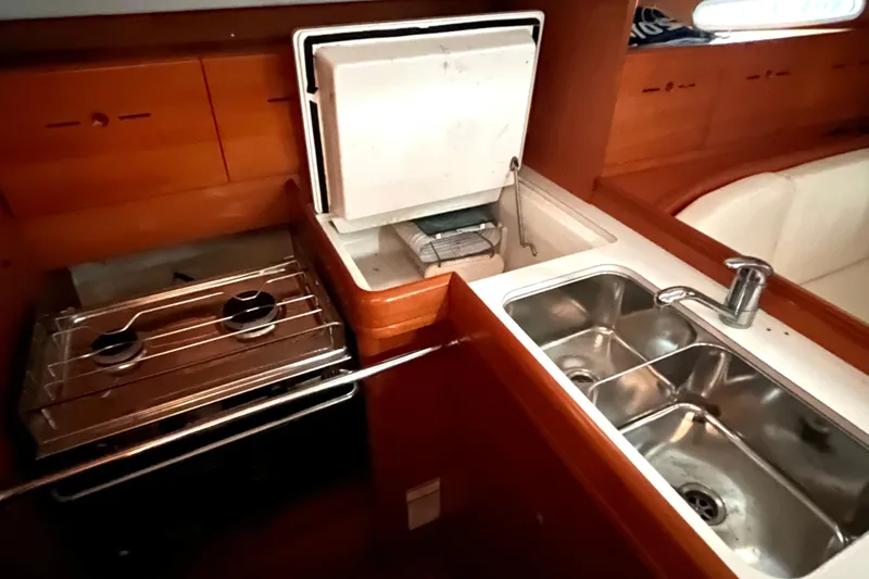 Slide: The Image of 2001 Beneteau First 40.7 yacht kitchen with stove, sink, and storage. - 8