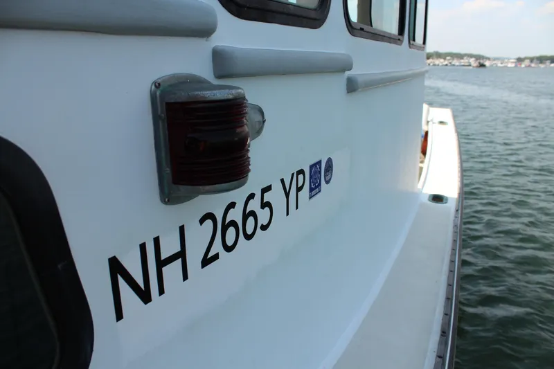Slide: The Image of 1992 Novi 32 Downeast boat with registration NH 2665 YP on calm water. - 15