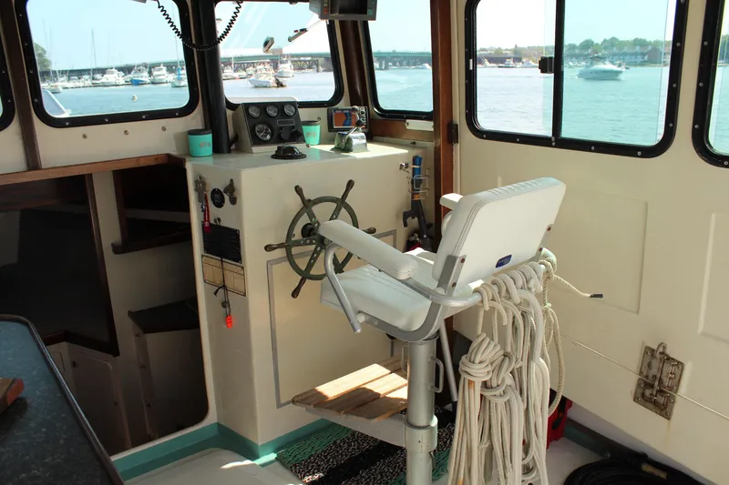 Slide: The Image of Interior of 1992 Novi 32 Downeast boat with steering wheel and captain's chair. - 18