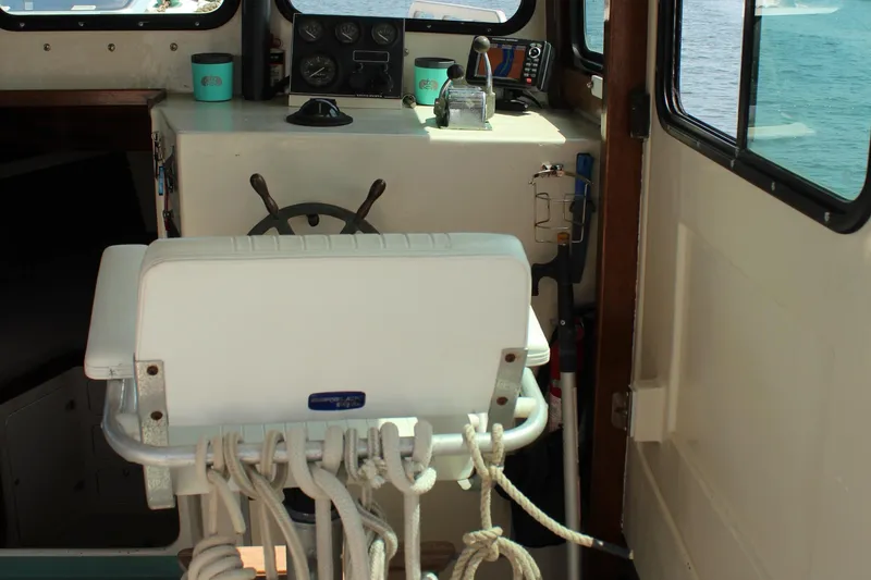 Slide: The Image of Interior of a 1992 Novi 32 Downeast boat with steering wheel and nautical equipment. - 21