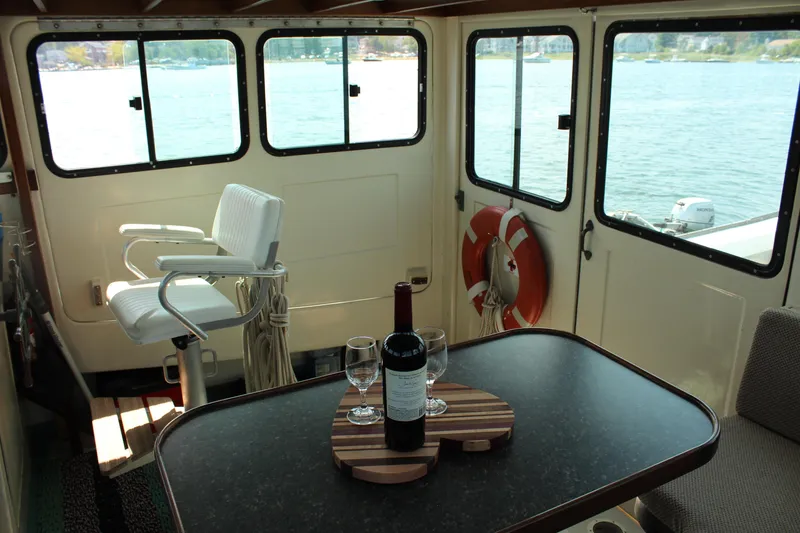 Slide: The Image of Interior of 1992 Novi 32 Downeast boat with wine on table, overlooking water. - 24