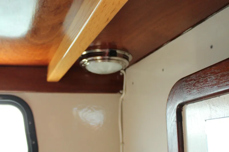 Slide: The Image of Interior of 1992 Novi 32 Downeast boat with wooden trim and ceiling light. - 36