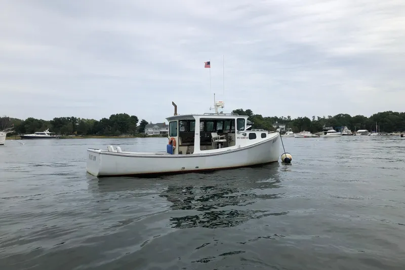 Slide: The Image of 1982 Stanley Greenwood/Novi 32 Downeast boat on calm water, overcast sky. - 4