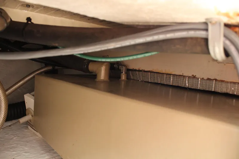 Slide: The Image of 1992 Novi 32 Downeast boat interior showing pipes and storage compartment. - 46