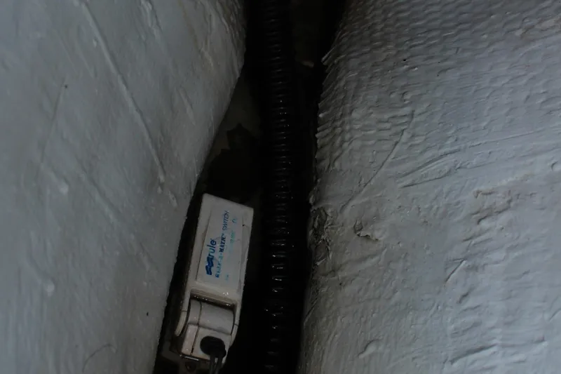 Slide: The Image of 1992 Novi 32 Downeast boat interior with Rule bilge pump switch and wiring. - 48