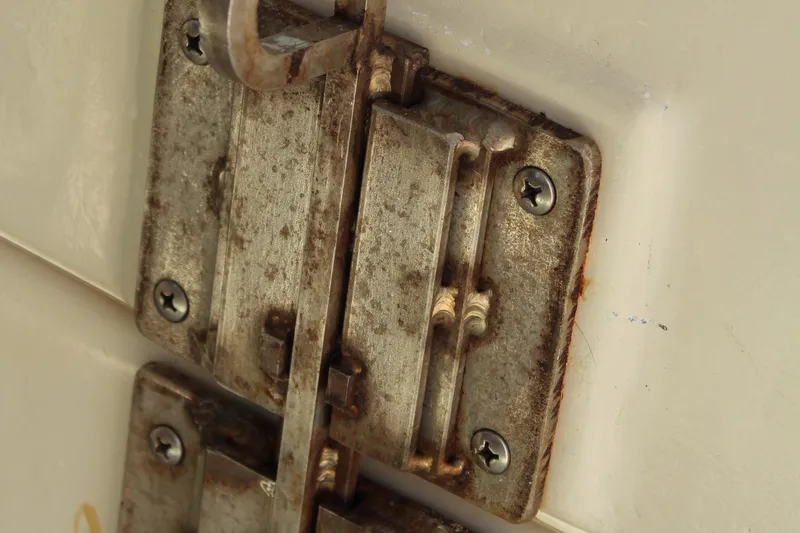 Slide: The Image of Rusty metal latch on a 1992 Novi 32 Downeast boat. - 50