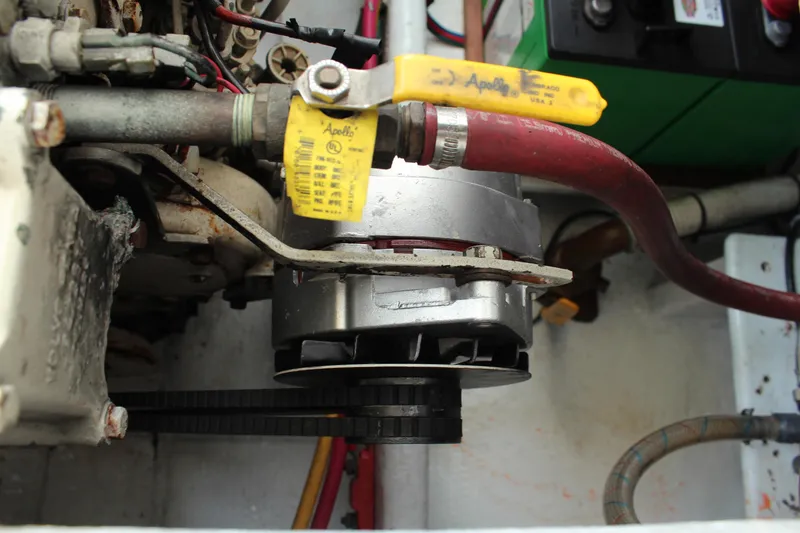 Slide: The Image of Engine compartment of a 1992 Novi 32 Downeast boat, featuring mechanical components and hoses. - 55