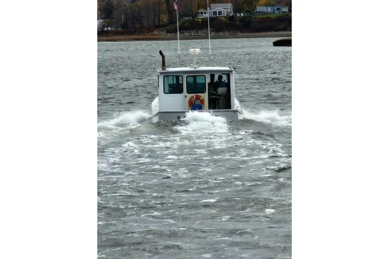 Slide: The Image of 1982 Stanley Greenwood/Novi 32 Downeast boat cruising on a calm river. - 7