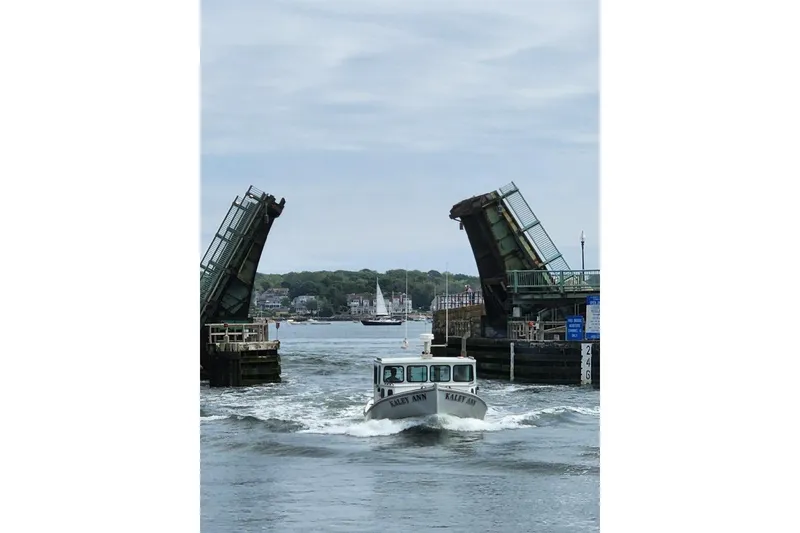 Slide: The Image of 1982 Stanley Greenwood/Novi 32 Downeast boat passing under raised drawbridge. - 8