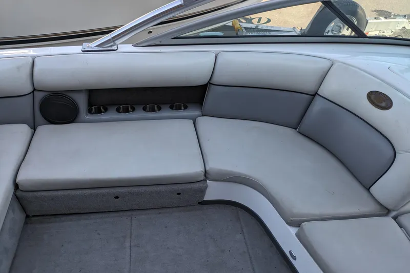 Slide: The Image of 2005 Supra Launch 21 V boat interior with gray seating and cup holders. - 11